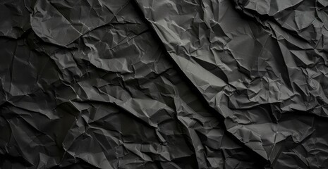 A black rolled paper texture with wrinkles, captured in a matte photo, appearing crumpled. - obrazy, fototapety, plakaty