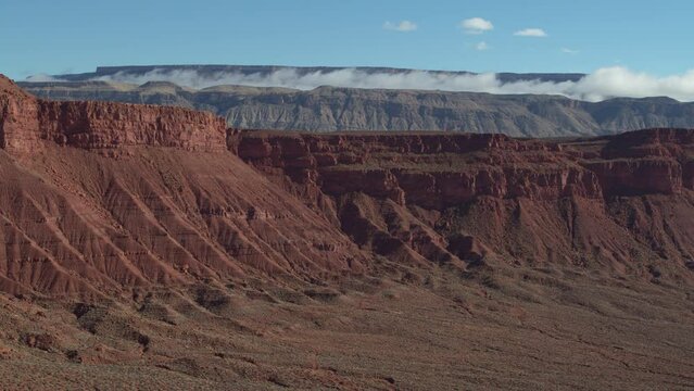 Aerial of red cliffs and low cloud inversion in St George Utah desert in Warner Valley in morning