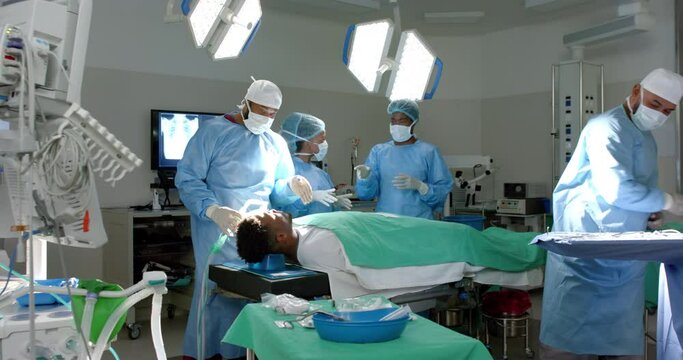 Diverse team of surgeons operate in a hospital, with copy space