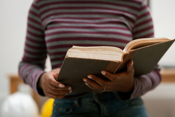 Religious concept. Belief. Close-up. A young woman praying thanks to the holy scriptures. God's teachings based on faith and faith in God, religion, belief, hope, love, praye