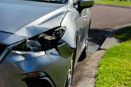 Smashed front of car in road accident headlight broken and car written off