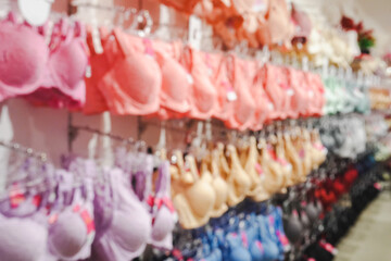 Blurred image interior of a colorful modern women lingerie and underwear store. Panties and bras at...