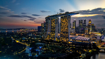 Singapore and Marina Bay skyscrapers. Aerial view at night from drone