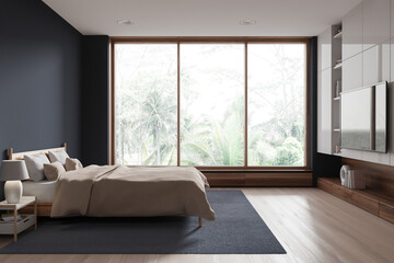 Modern hotel bedroom interior with bed with tv screen, shelf and window