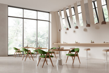Cozy cafe interior with chairs and bar table near panoramic window