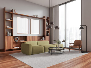 White living room corner with green couch and posters