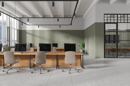 Modern workspace interior with armchairs and pc desktop, panoramic window