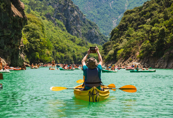 Lake of Sainte Croix du Verdon in the Verdon Natural Regional Park, France with kayaks and boats, adventure travel.