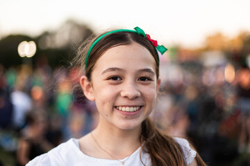 tween girl smiling at a community event with a Christmas hairband