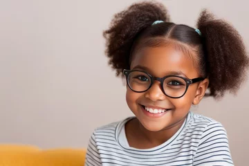 Fotobehang Smiling cute little african american girl wearing glasses looking at camera. Portrait of happy female child on a gray background © irena_geo