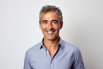Handsome middle-aged man with gray hair and blue shirt.