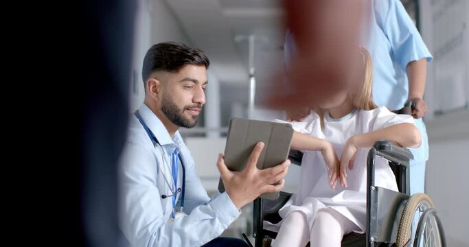 Doctor discussing with a young Caucasian girl in a hospital, with copy space