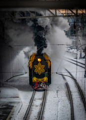 Steam locomotive with a red snowflake on the top of it.