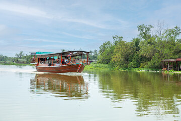 Tourists boat of bangkok crosses the Nakhon Chai Si River