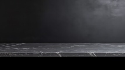 Black marble countertop on black background with spotlight and copy space.