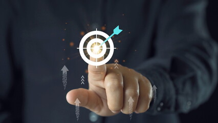 Businessman throwing red arrow dart to virtual target dart board. Setup objectives and target for...