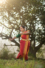 Obraz na płótnie Canvas Female Indian Bharatanatyam dancer performing arts in various locations. 