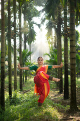 Female Indian  Bharatanatyam dancer performing arts in various locations. 
