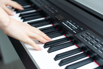 keyboard and hands playing the piano