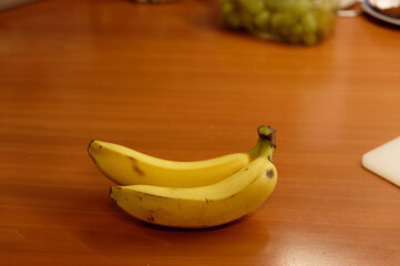 Beautiful fresh yellow banana on the table. Healthy food - fruit for a snack.