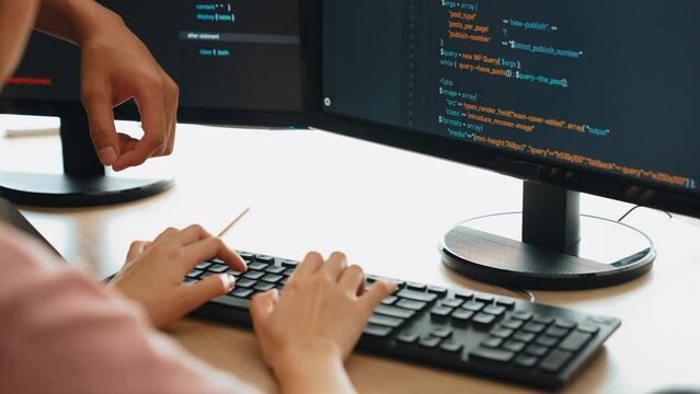 Slow motion back end or software developer manager supervising his team on new application program development on debugging and solving complex code algorithms on monitor. Burgeoning