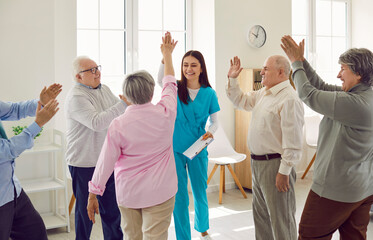 Group of happy lively joyful senior people having fun at retirement home. Good friendly smiling...