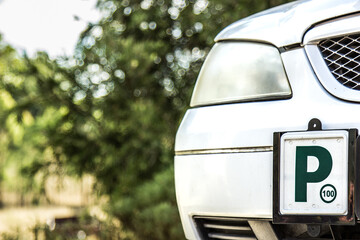 Green P2 license plate on the front of a car