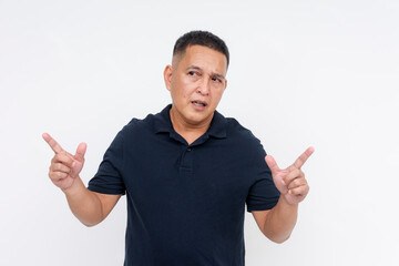 A confused and perplexed asian man has to decide between two options. Pointing both to the left and right. Isolated on a white background.
