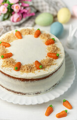 Homemade Easter carrot cake made with walnuts, iced with cream cheese. Sweet dessert.