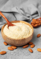 Fresh almond flour in a  bowl and almonds