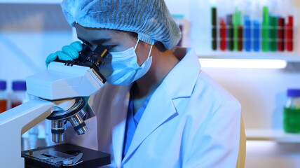 Scientists are doing research in a science lab. A medical chemist in a white coat, gloves and goggles looks at a glass tube. Compare two different liquid samples. and discuss future experiments.