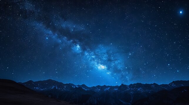 Night sky with stars and milky way over the mountains. Starry sky background.