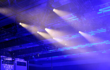 Ambient and spotlights in a dark room shining from the ceiling