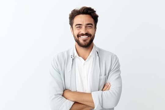 Portrait of handsome smiling man with crossed arms standing against white background