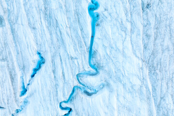 An aerial view of an iceberg and river. Winter landscape from a drone. View of the moraines....