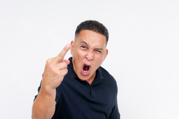 A furious Asian adult expressing anger and annoyance, giving the middle finger in a rude gesture, while cussing and hurling insults. Isolated on a white backdrop.