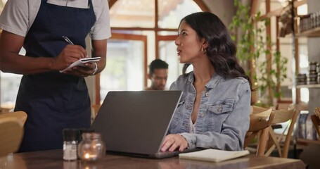 Cafe, waitress and freelancer customer with laptop, typing feedback for restaurant review blog on social media. Coffee shop, order and woman with remote work and server writing menu info on notebook
