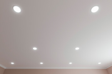 Recessed ceiling lights in a white stretch ceiling.