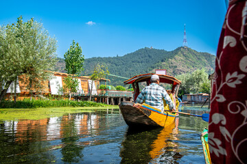 Obraz premium Dal Lake and the beautiful mountain range in the background in the summer Boat Trip of city Srinagar Kashmir India. 