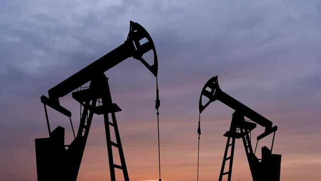 Timelapse of oil rigs at sunset. Oil industry