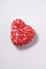 Fototapeta premium Heart shaped donut with glaze on white background