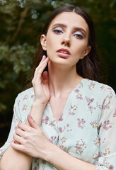 Gorgeous sweet girl in park. Outdoor close-up portrait of beautiful young woman in dress