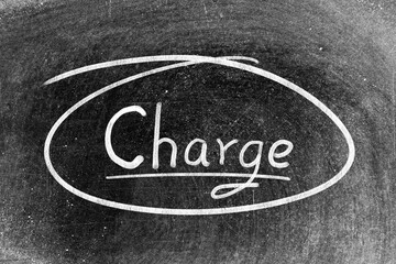 White chalk hand writing in word charge and circle shape on blackboard background