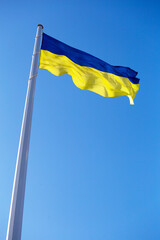 National flag of Ukraine against blue sky