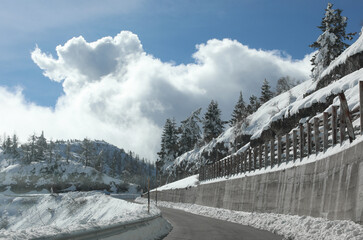 dangerous high mountain icy asphalt road in winter with freshly fallen snow