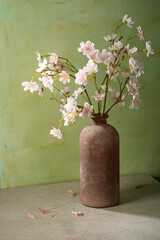 Pink flowers in vase green background