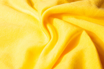 Bright, yellow, soft, fluffy, light blanket. Texture cotton textile background