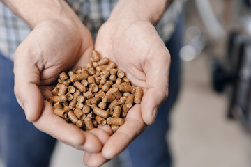 Closeup hops in pellet before brewing for craft beer on background tank. Brewery factory, Brewer control raw material for quality