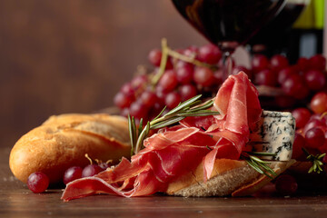 Sandwich with prosciutto, blue cheese and rosemary. - obrazy, fototapety, plakaty