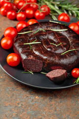 Black pudding or blood sausage with rosemary and tomatoes.